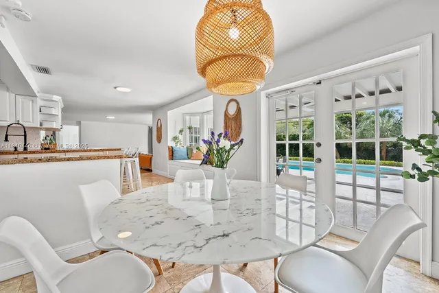 a view of a dining room with furniture and chandelier