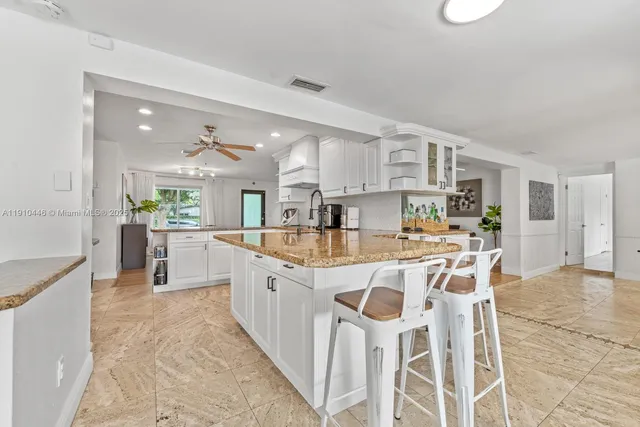 a kitchen with a refrigerator and a stove top oven