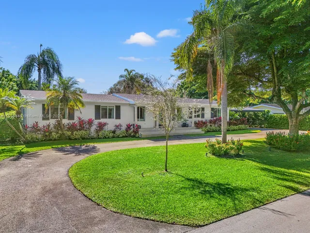 front view of a house with a backyard