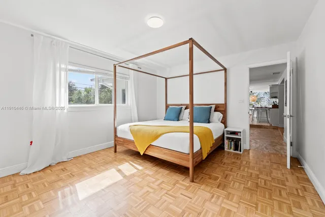 a spacious bedroom with a bed and a window