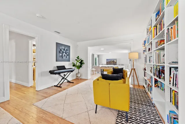 a living room with furniture and a book shelf