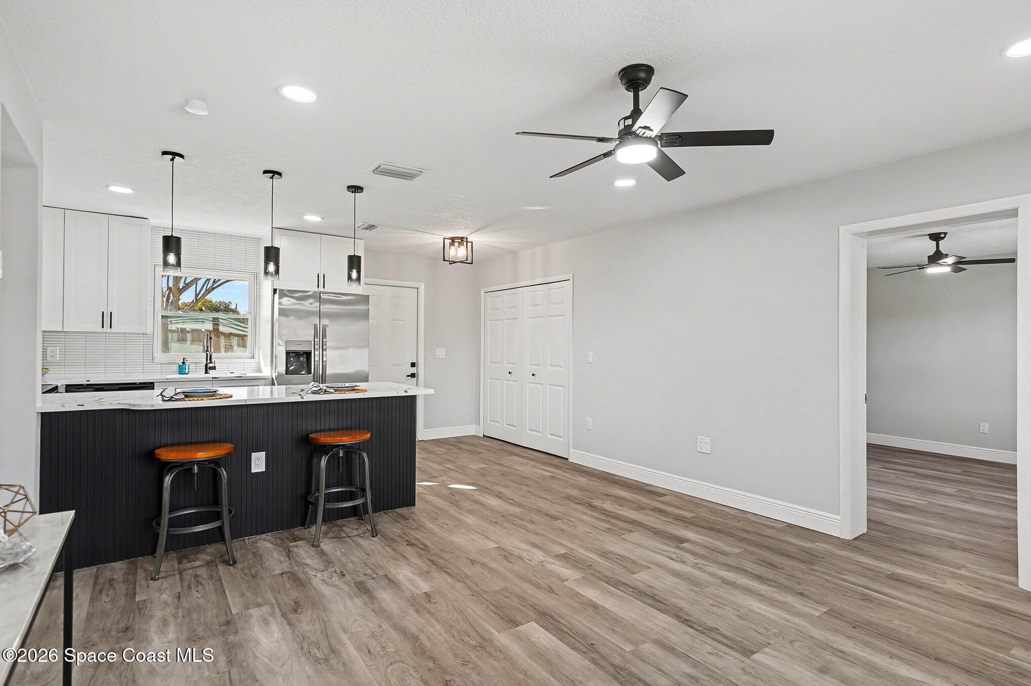 2793 North Breeze Road Melbourne, FL 32935 - Photo 4 of 14 a view of kitchen with wooden floor and window