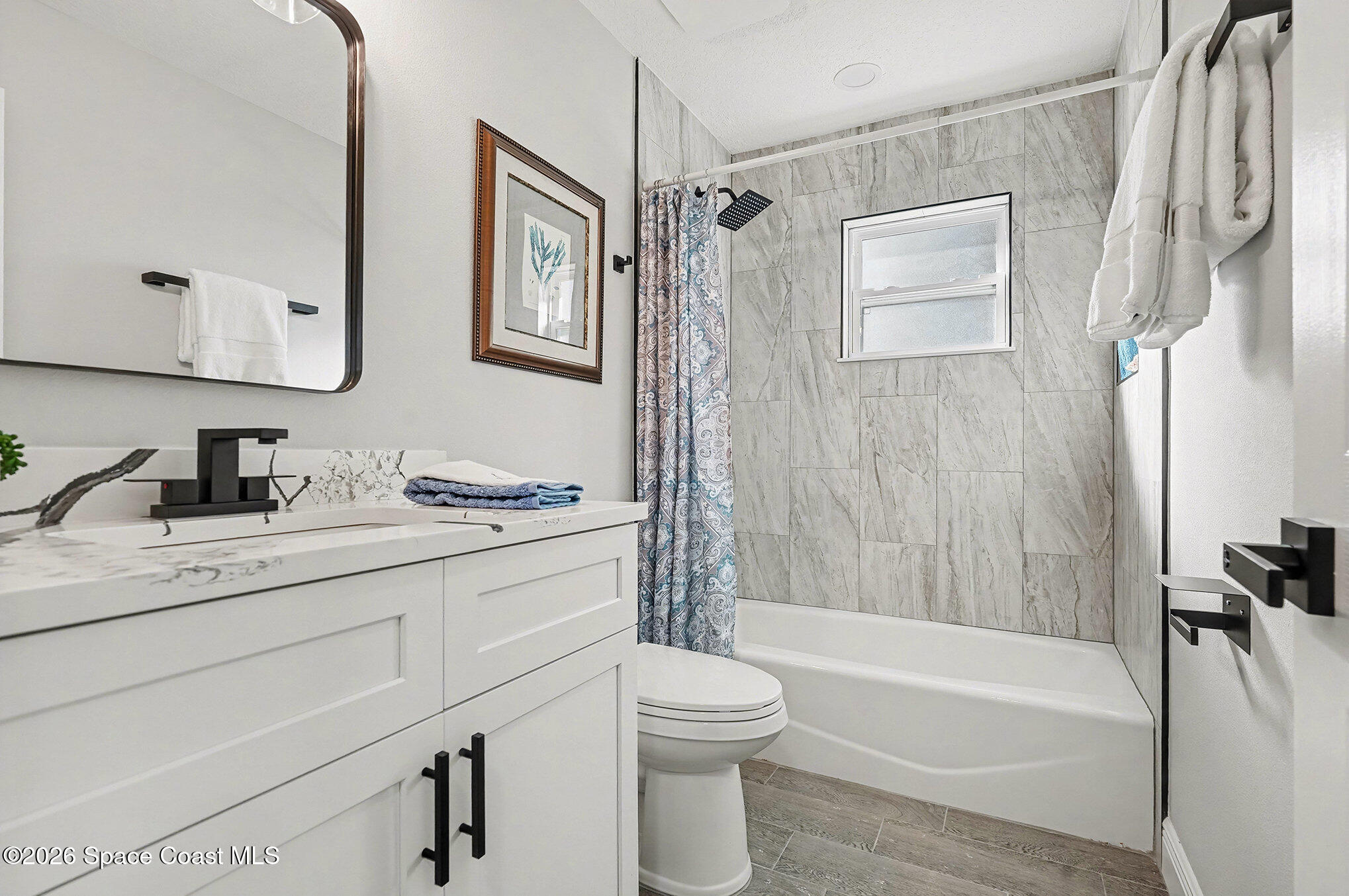 2793 North Breeze Road Melbourne, FL 32935 - Photo 8 of 14 a bathroom with a granite countertop sink toilet and shower