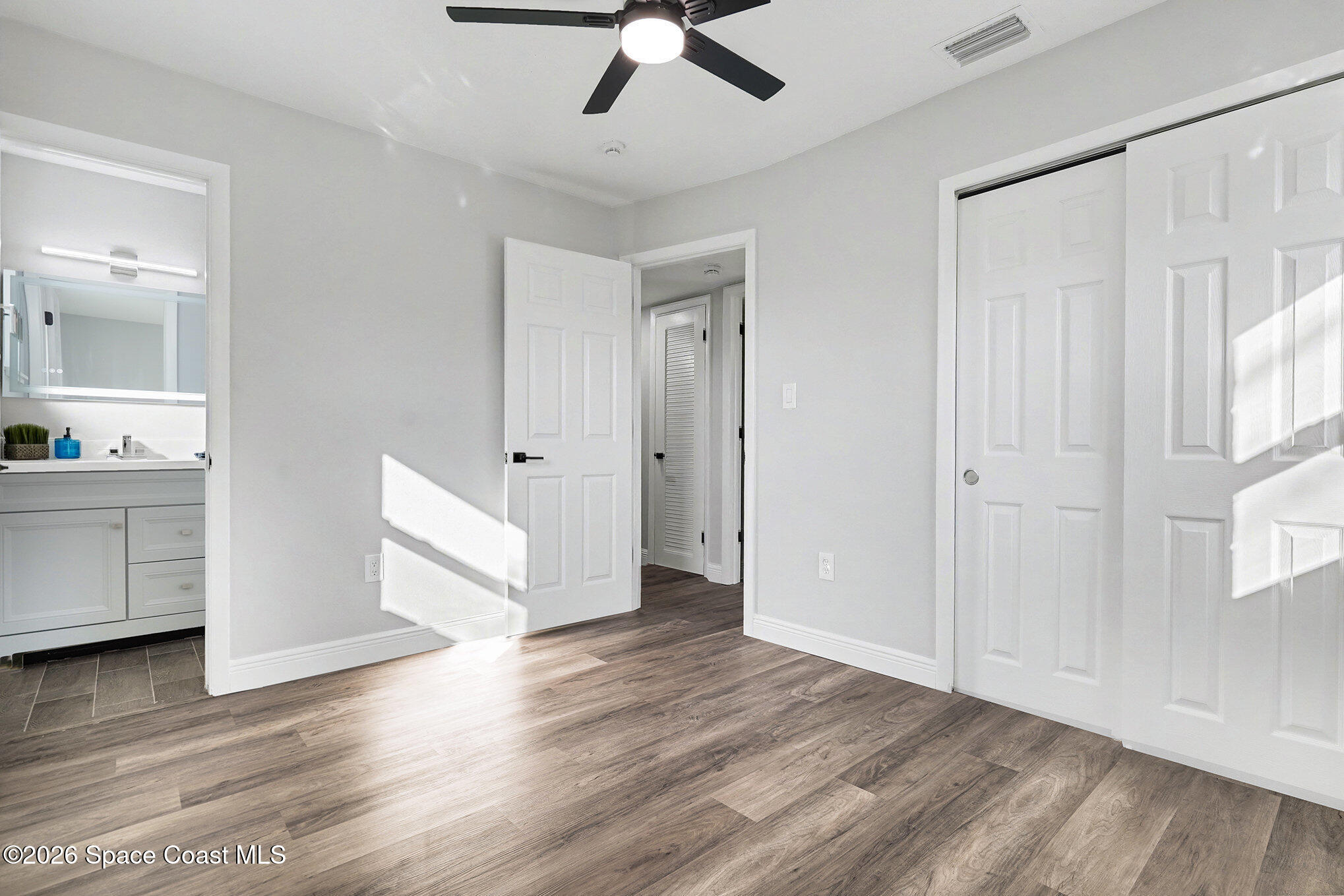 2793 North Breeze Road Melbourne, FL 32935 - Photo 9 of 14 a view of an empty room with window and wooden floor