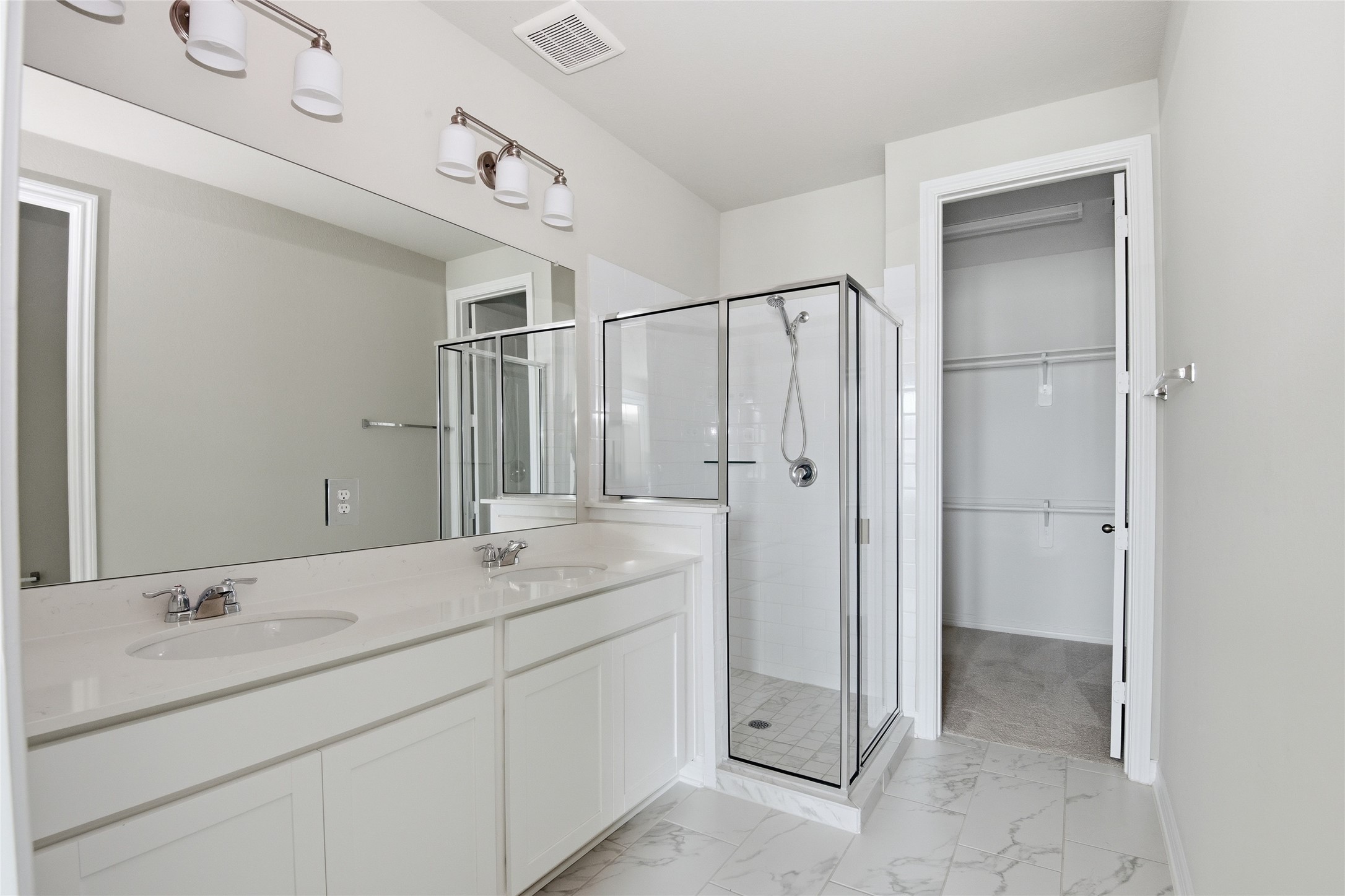 9406 Caddo Ridge Lane Cypress, TX 77433 - Photo 12 of 16 a bathroom with a double vanity sink mirror and shower