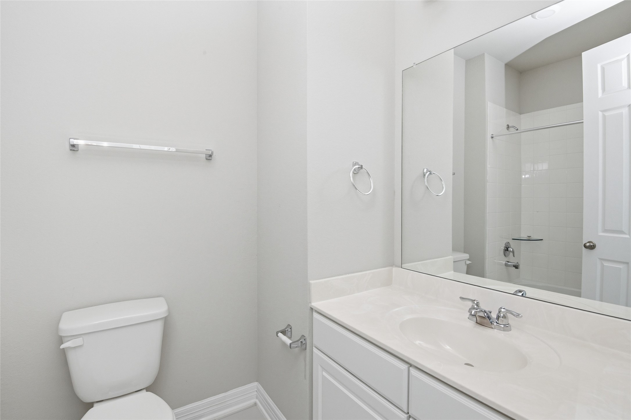 9406 Caddo Ridge Lane Cypress, TX 77433 - Photo 13 of 16 a bathroom with a toilet sink and mirror