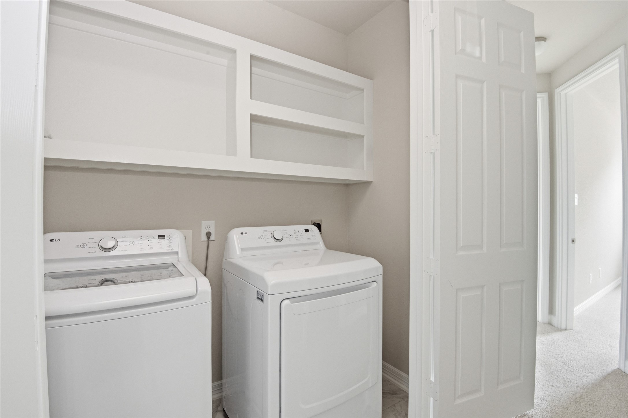 9406 Caddo Ridge Lane Cypress, TX 77433 - Photo 16 of 16 a view of storage and utility room with washer and dryer