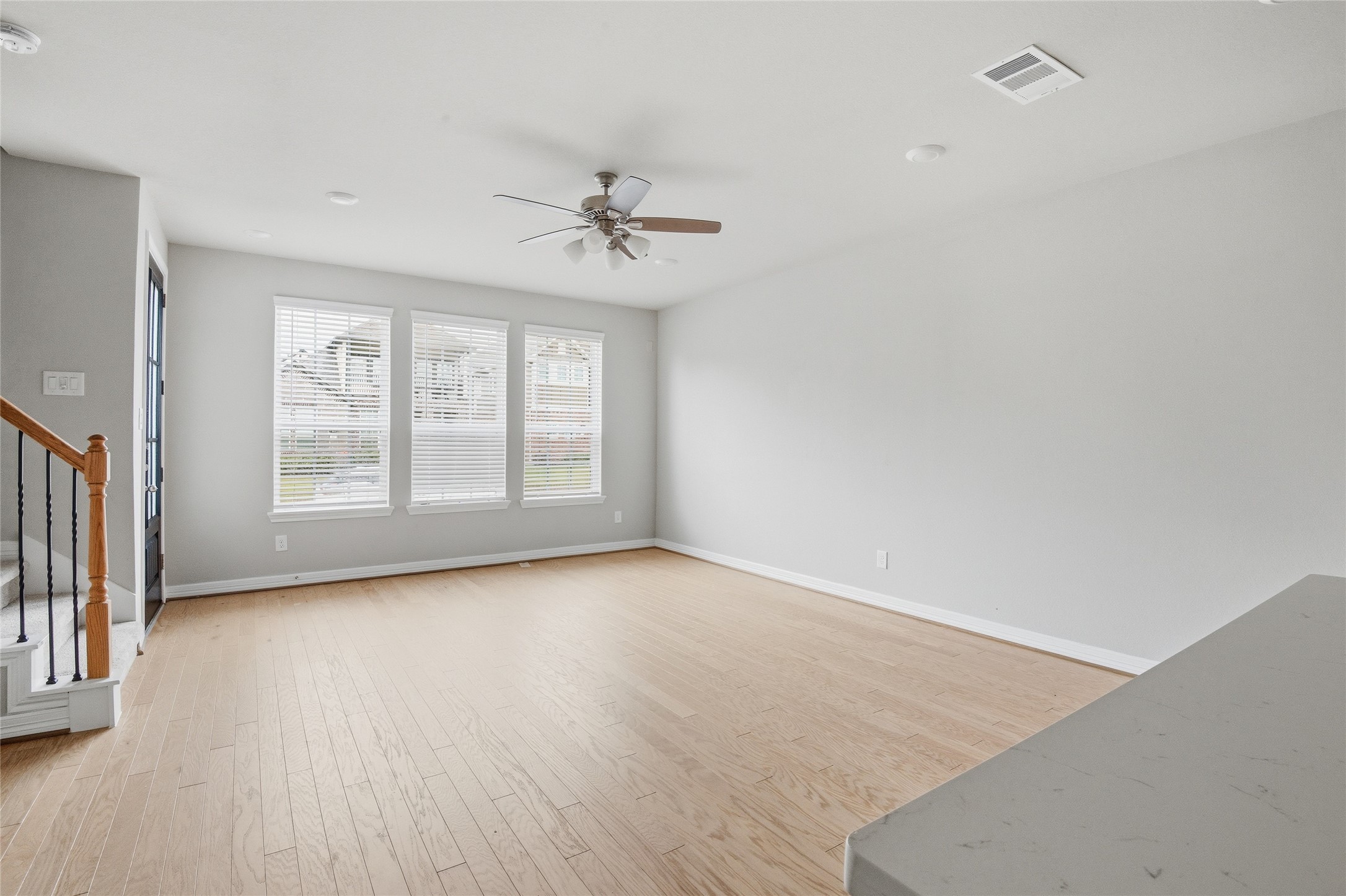 9406 Caddo Ridge Lane Cypress, TX 77433 - Photo 2 of 16 a view of an empty room with a window and wooden floor