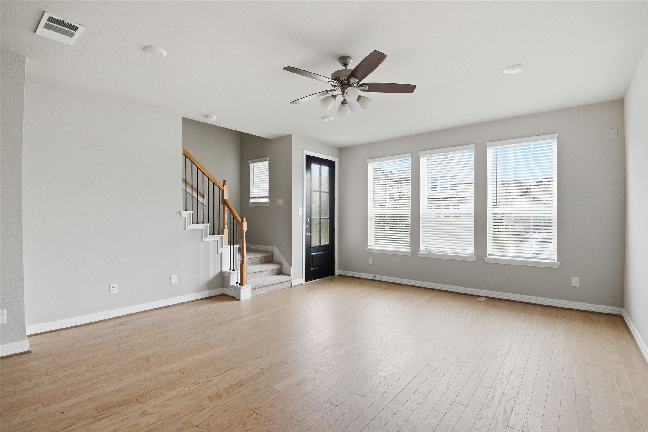 9406 Caddo Ridge Lane Cypress, TX 77433 - Photo 3 of 16 a view of an empty room with a window and wooden floor
