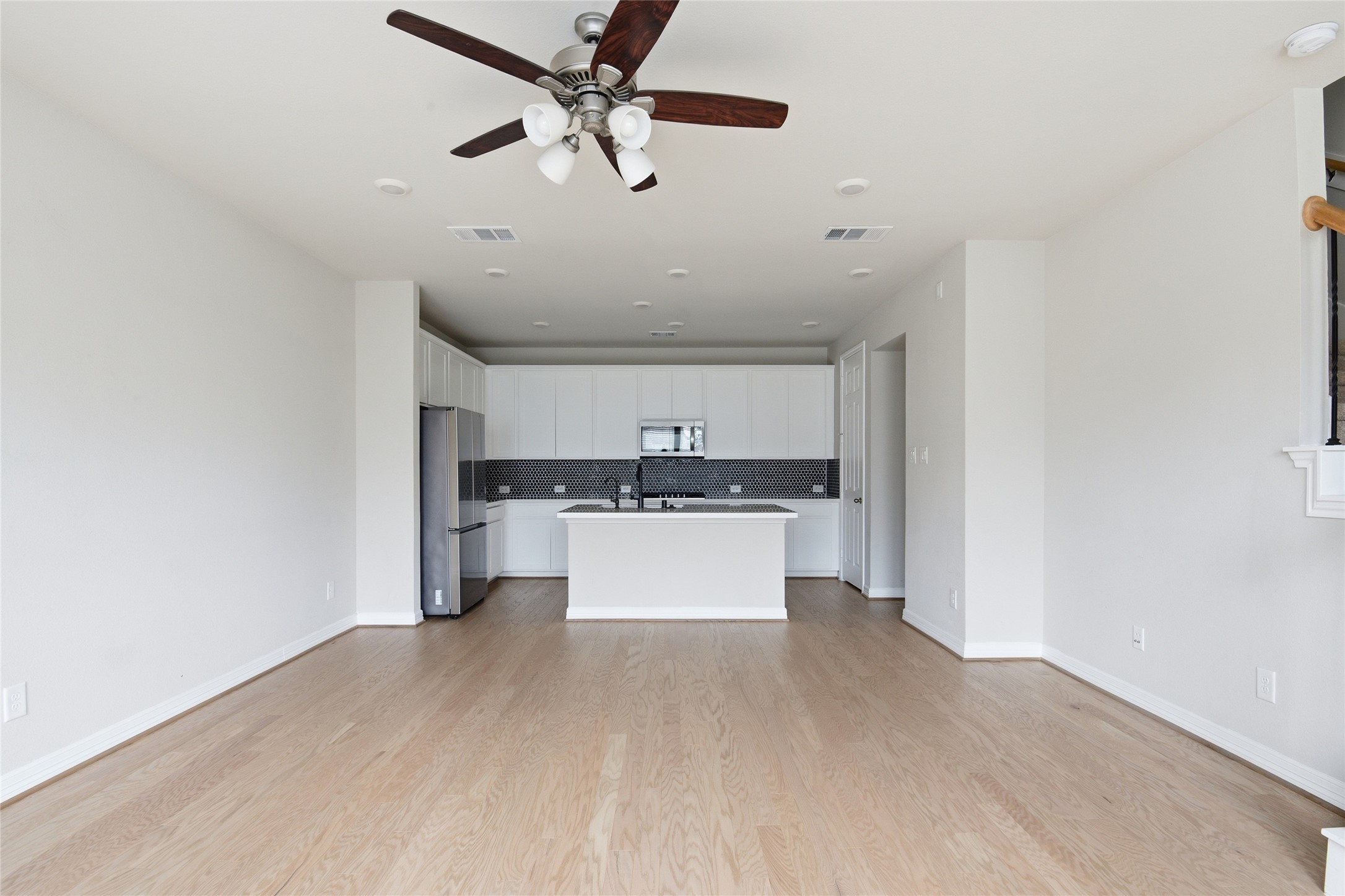 9406 Caddo Ridge Lane Cypress, TX 77433 - Photo 5 of 16 a view of a kitchen with a sink stainless steel appliances and cabinets