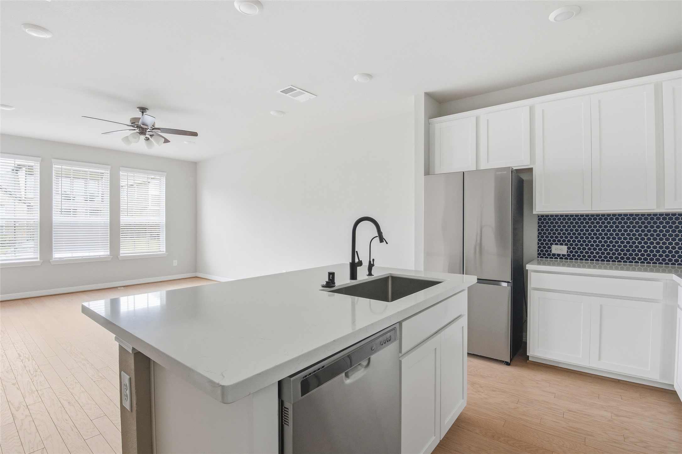9406 Caddo Ridge Lane Cypress, TX 77433 - Photo 8 of 16 a kitchen that has a sink and a refrigerator
