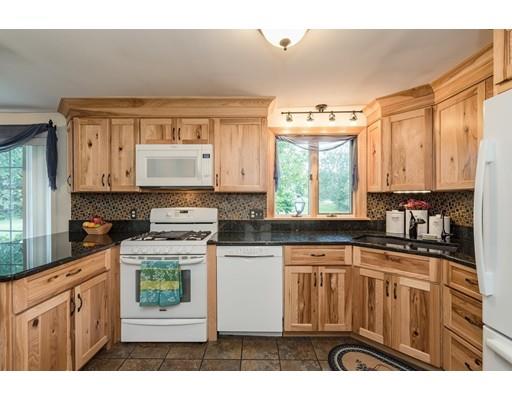361 Oakham Road New Braintree, MA 01531 - Photo 3 of 30 a kitchen with stainless steel appliances granite countertop a stove a sink dishwasher and white cabinets with wooden floor