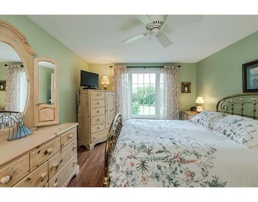 361 Oakham Road New Braintree, MA 01531 - Photo 10 of 30 a bedroom with a bed a dresser and flat screen tv