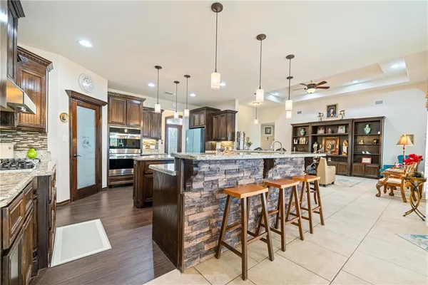 a large kitchen with a table and chairs