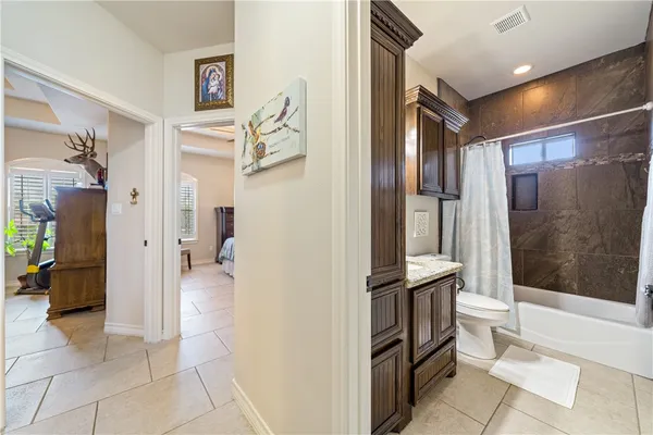 a bathroom with a glass shower door and a sink