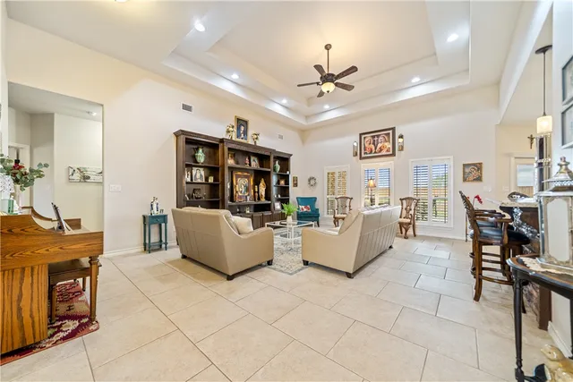 a view of a dining room with furniture and a chandelier