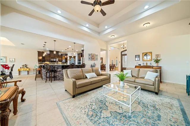 a kitchen with kitchen island granite countertop a sink a stove and a refrigerator