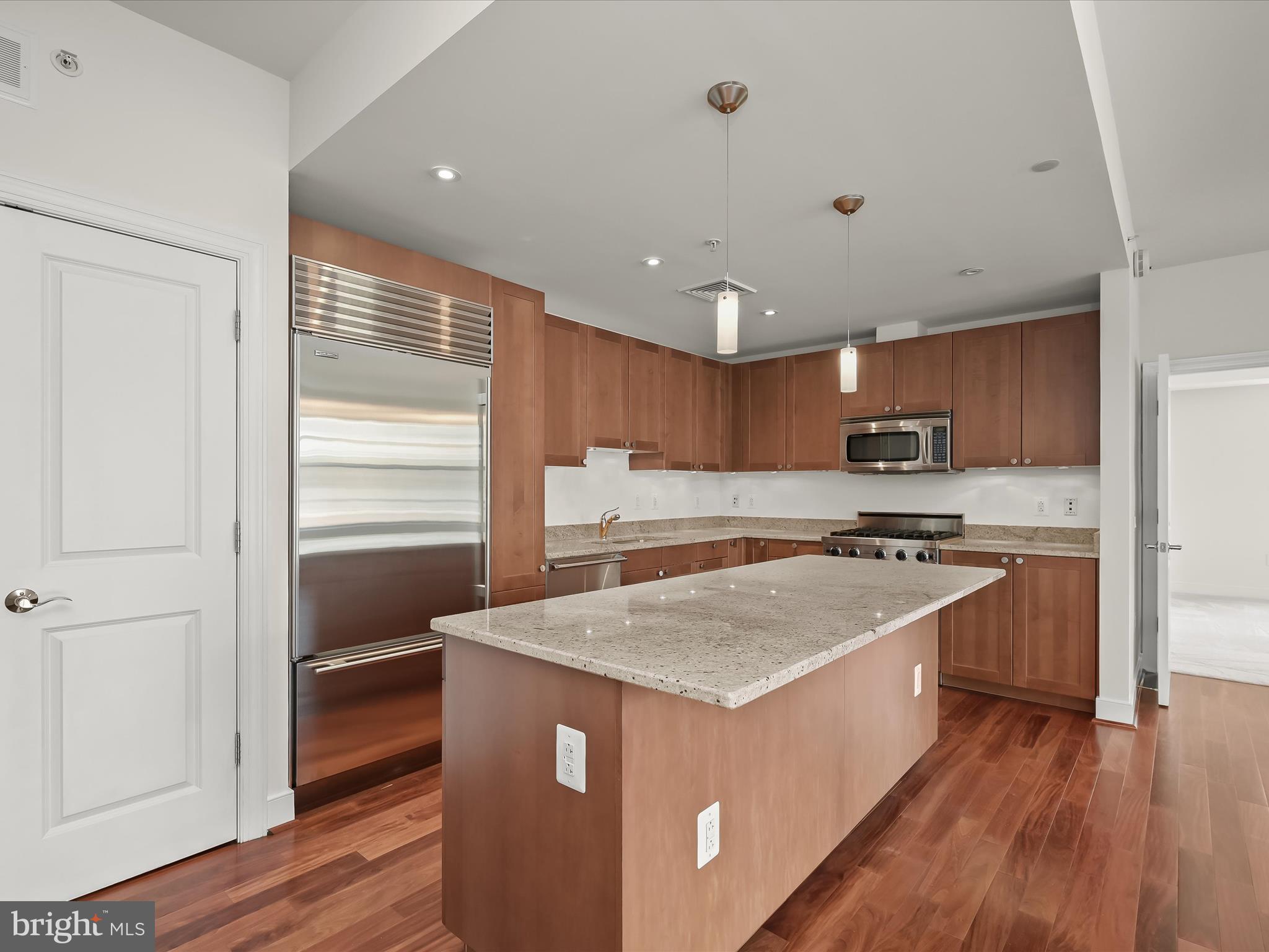 2425 L Street Northwest, Unit 536 Washington, DC 20037 - Photo 12 of 41 a kitchen with stainless steel appliances granite countertop a stove a sink and a refrigerator