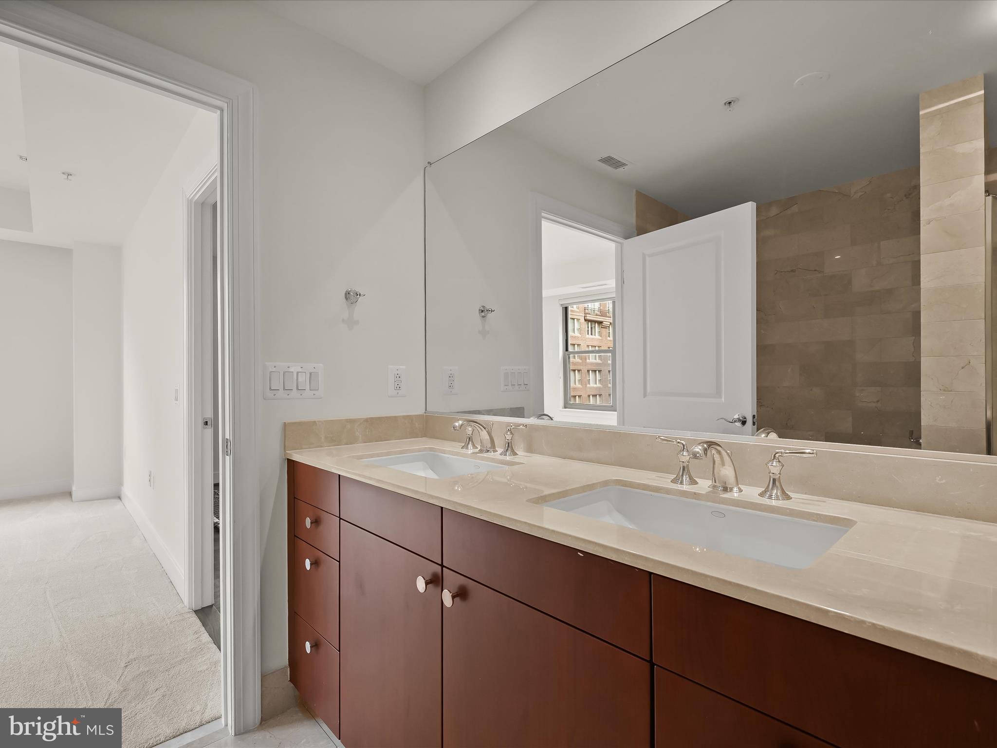 2425 L Street Northwest, Unit 536 Washington, DC 20037 - Photo 22 of 41 a bathroom with a sink and a mirror