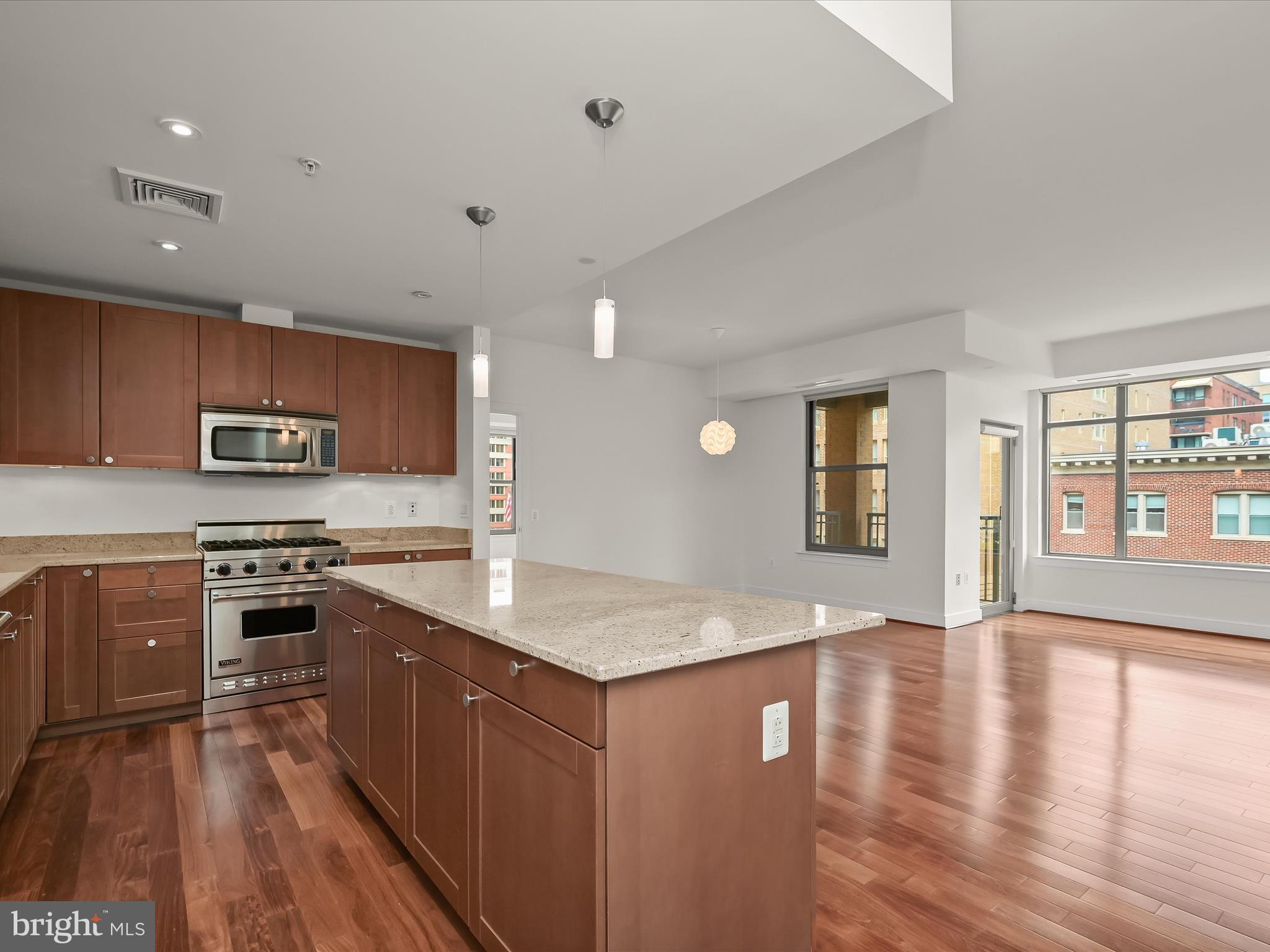 2425 L Street Northwest, Unit 536 Washington, DC 20037 - Photo 5 of 41 a kitchen with stainless steel appliances granite countertop a stove a sink and a refrigerator