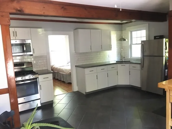 a kitchen with stainless steel appliances a stove a sink and a refrigerator
