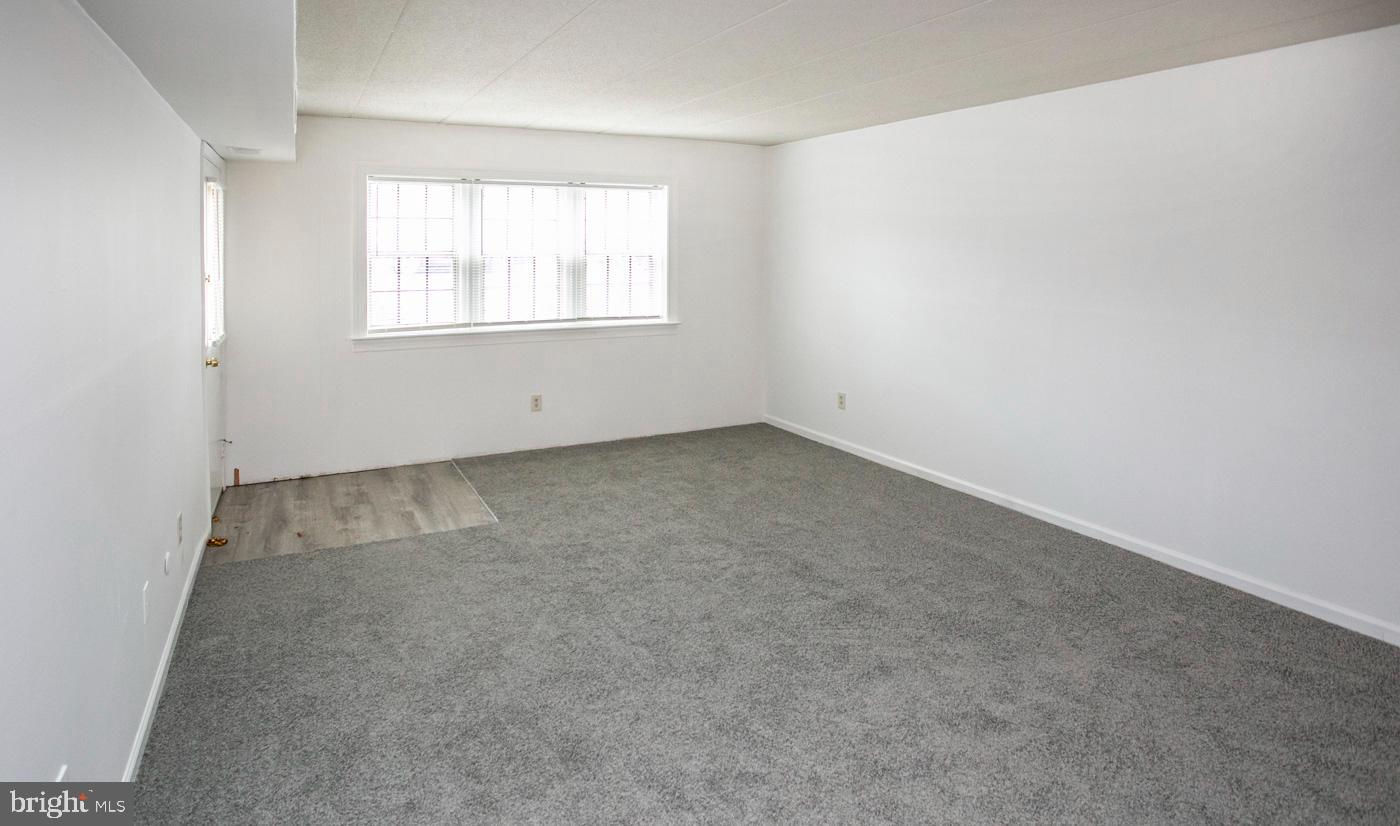 154 Woodstream Drive, Unit CONDO 154 Jeffersonville, PA 19403 - Photo 12 of 34 an empty room with windows