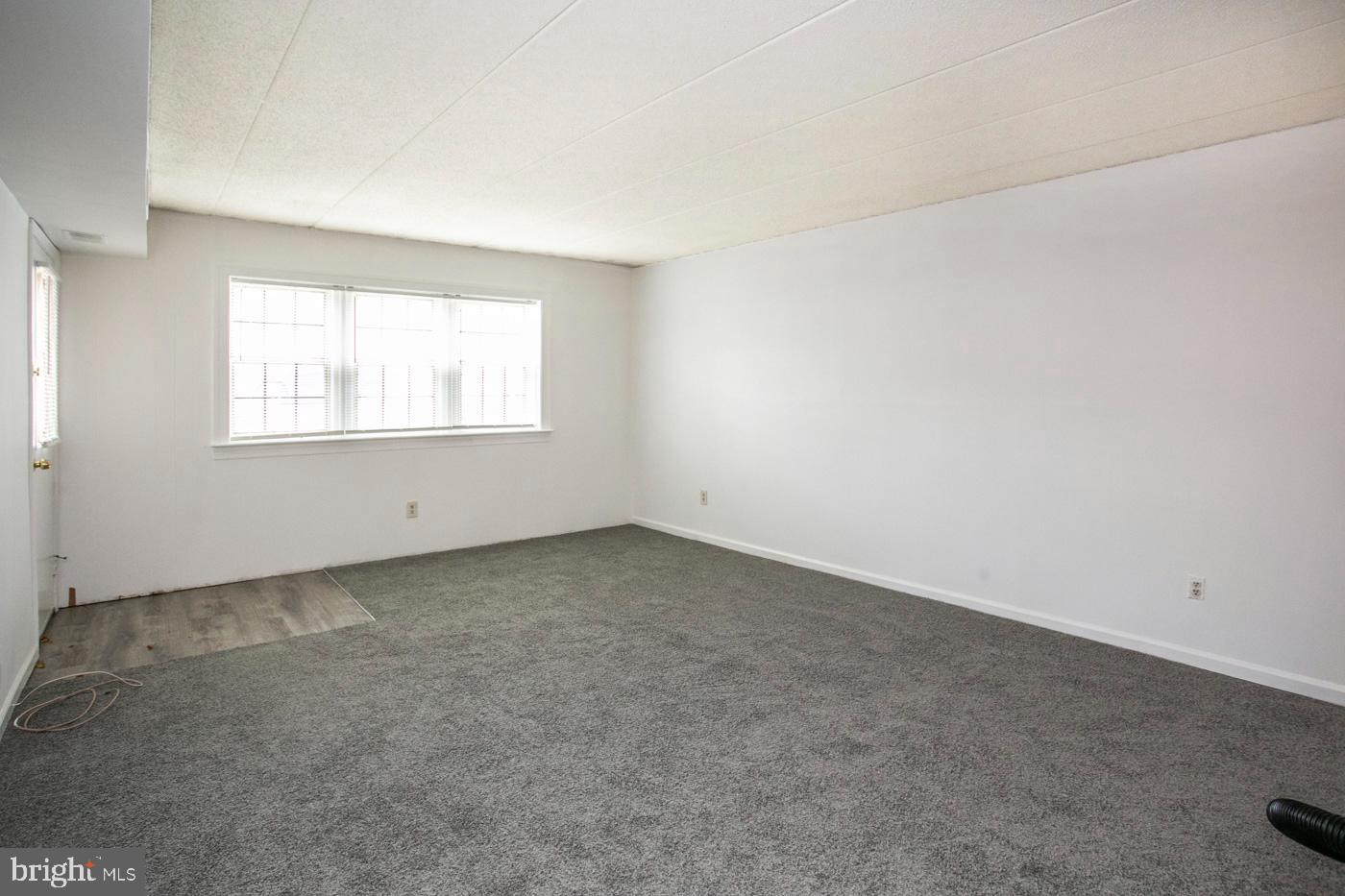 154 Woodstream Drive, Unit CONDO 154 Jeffersonville, PA 19403 - Photo 13 of 34 an empty room with windows