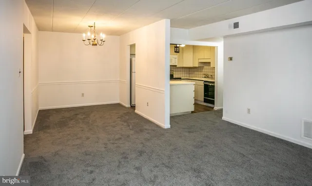 a view of a kitchen with a sink and dishwasher a refrigerator a fireplace