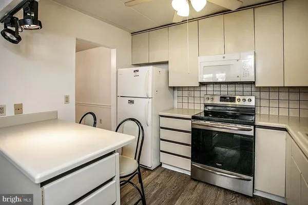 a kitchen with a stove a sink and a refrigerator