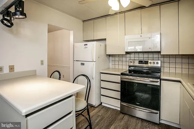 a kitchen with a stove a sink and a refrigerator