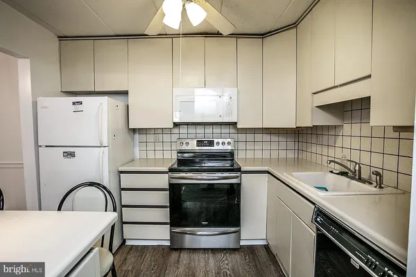 a kitchen with a sink cabinets and stainless steel appliances