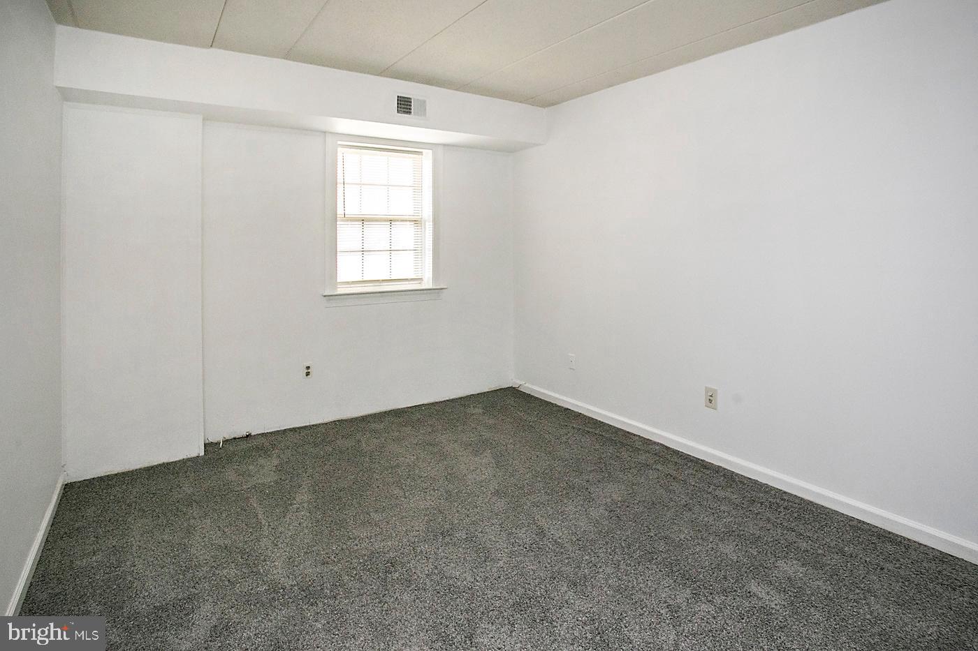 154 Woodstream Drive, Unit CONDO 154 Jeffersonville, PA 19403 - Photo 27 of 34 an empty room with a window