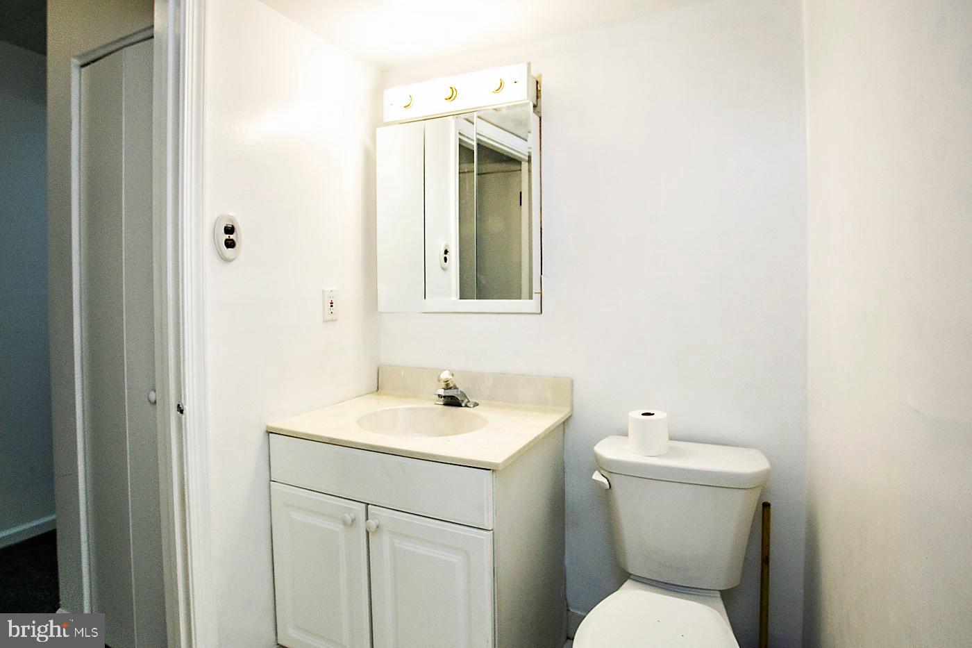 154 Woodstream Drive, Unit CONDO 154 Jeffersonville, PA 19403 - Photo 31 of 34 a bathroom with a toilet sink and mirror