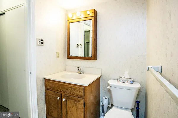 a bathroom with a toilet sink and mirror