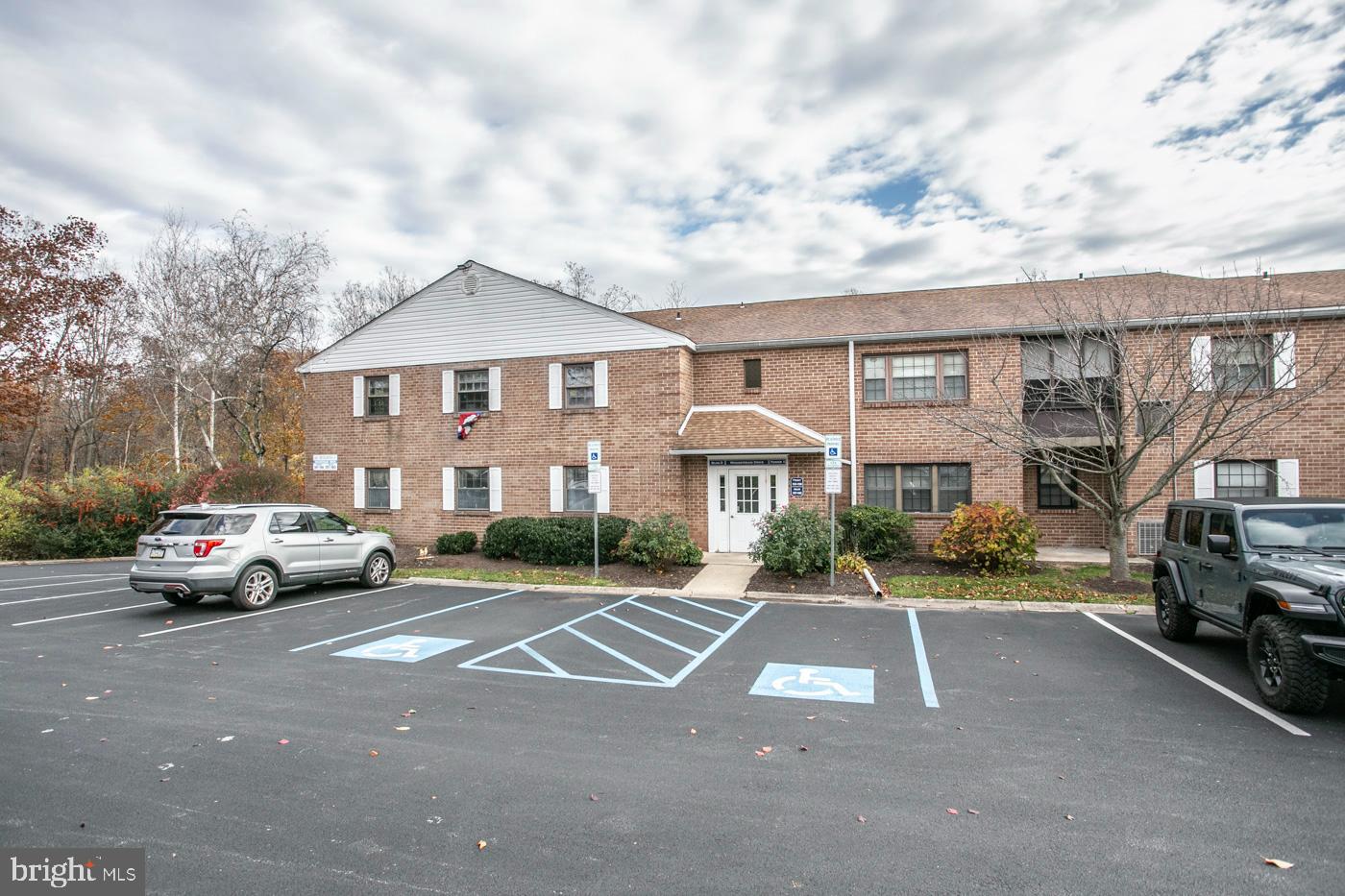 154 Woodstream Drive, Unit CONDO 154 Jeffersonville, PA 19403 - Photo 4 of 34 a view of street with parked cars