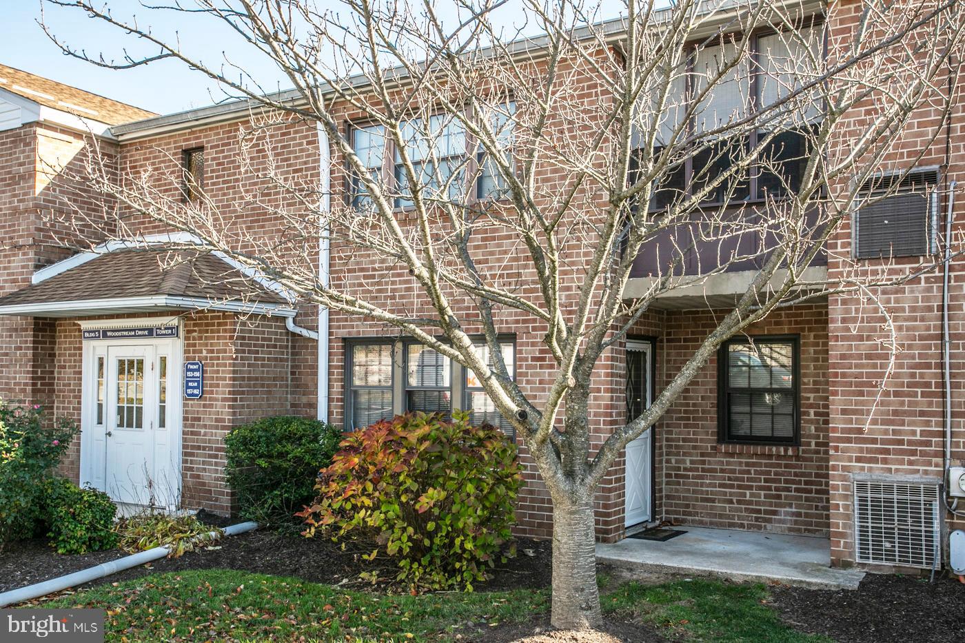 154 Woodstream Drive, Unit CONDO 154 Jeffersonville, PA 19403 - Photo 10 of 34 a front view of a house with a yard