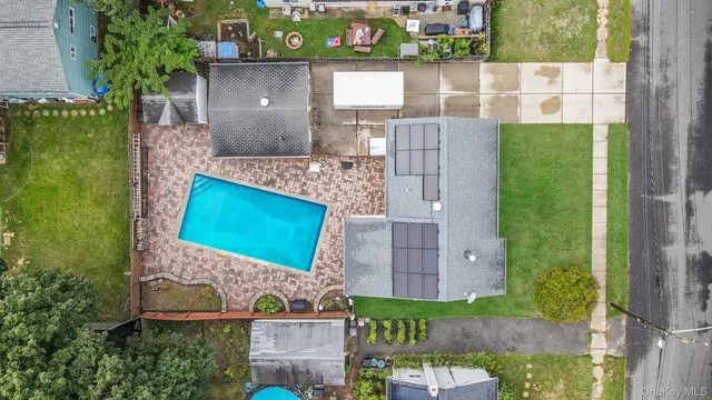 an aerial view of a house with a yard