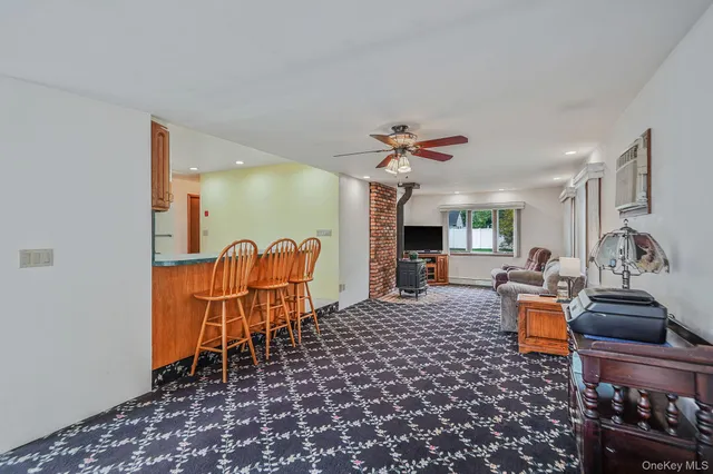 a living room with furniture a rug and a chandelier