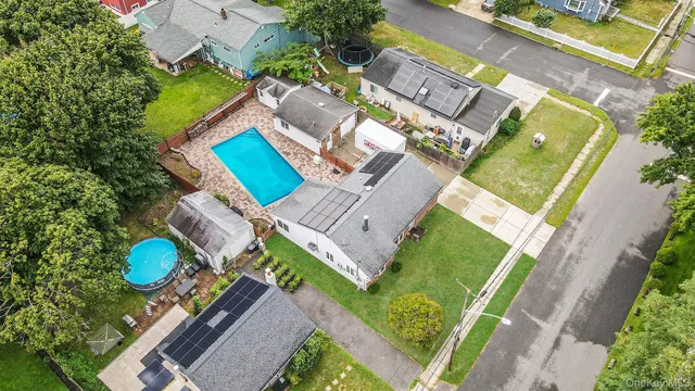 an aerial view of a house with a garden and trees