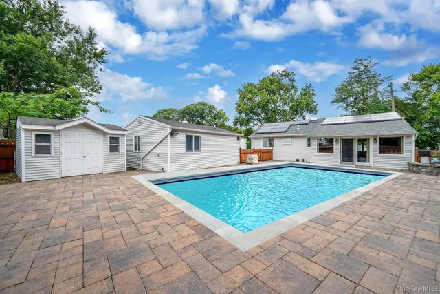 a front view of house with yard and trees