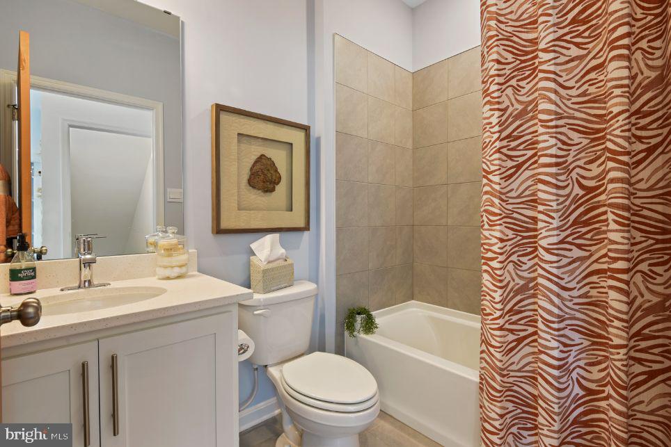 453 Ensemble Way Frederick, MD 21701 - Photo 13 of 34 a bathroom with a toilet a sink a mirror a bathtub and shower