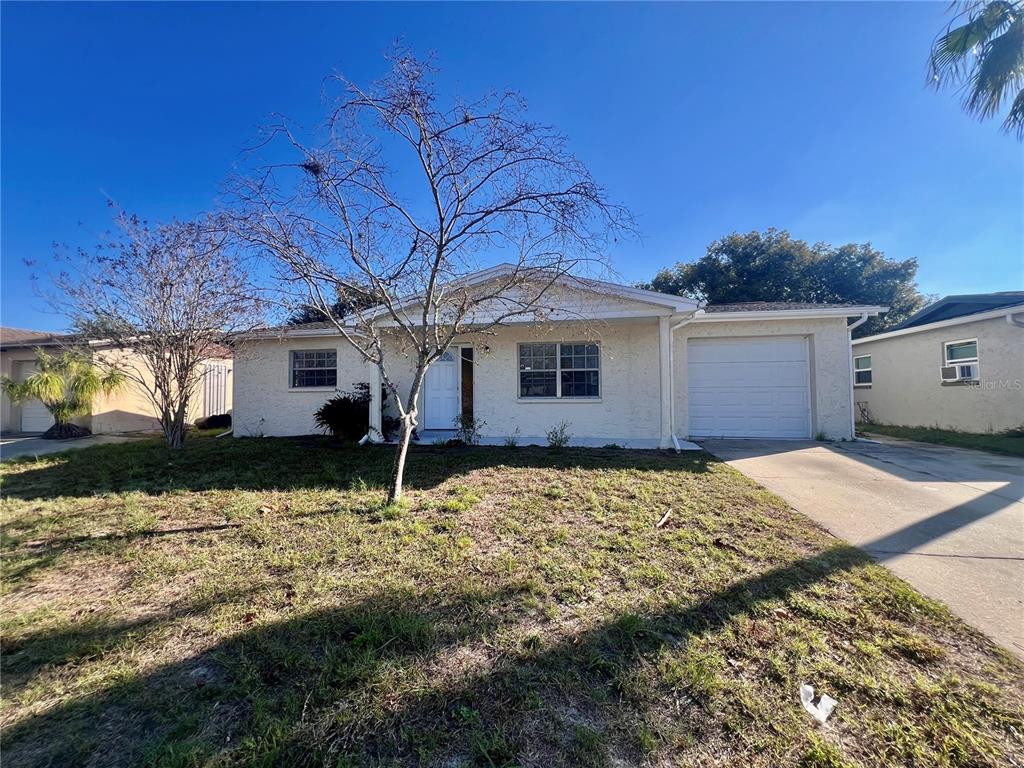 9504 Richwood Lane Port Richey, FL 34668 - Photo 2 of 16 a house view with a backyard space