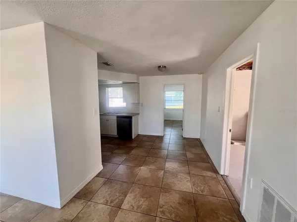 a view of a hallway to rooms and stairs
