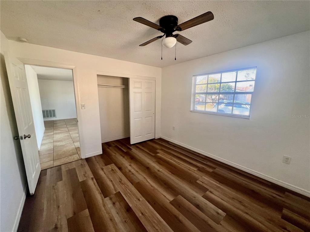 9504 Richwood Lane Port Richey, FL 34668 - Photo 10 of 16 wooden floor in an empty room with a window