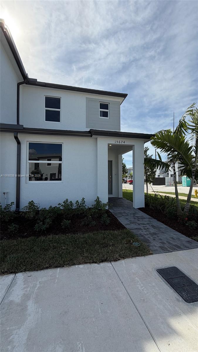 a front view of a house with garden