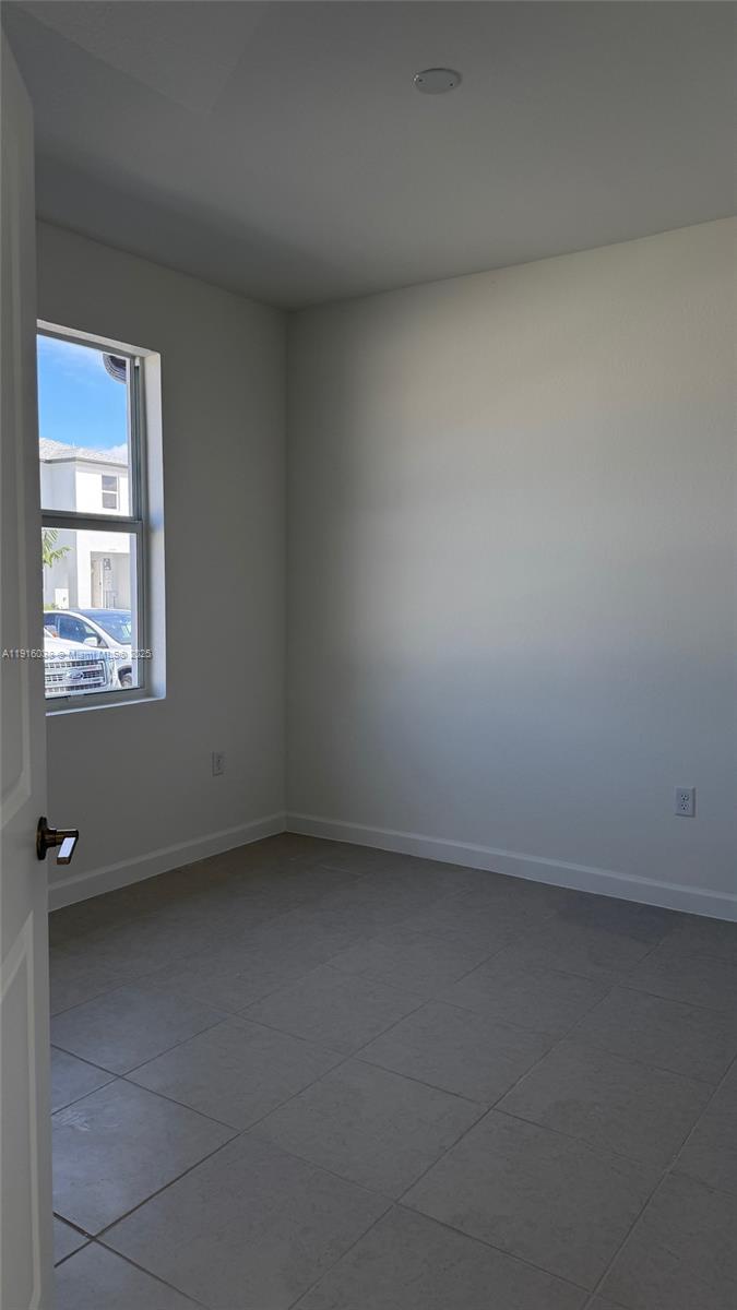 15624 Southwest 276th Terrace Homestead, FL 33031 - Photo 3 of 14 an empty room with a window