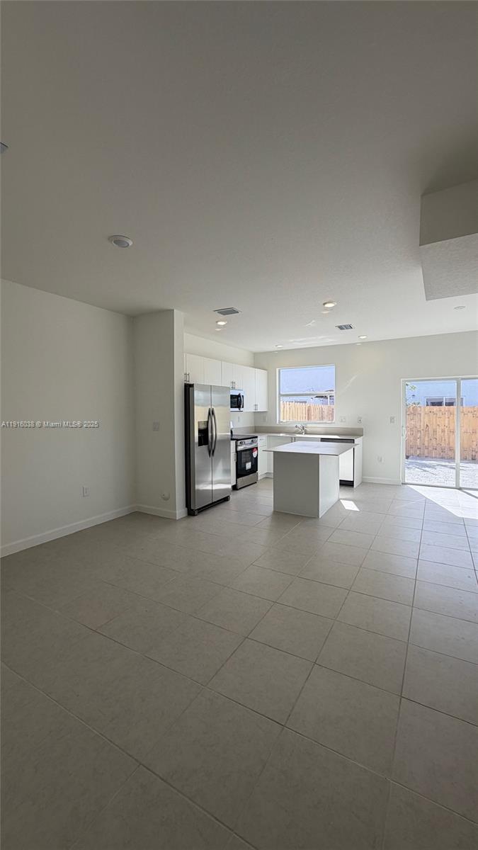15624 Southwest 276th Terrace Homestead, FL 33031 - Photo 4 of 14 a room with a washing machine and a cabinets