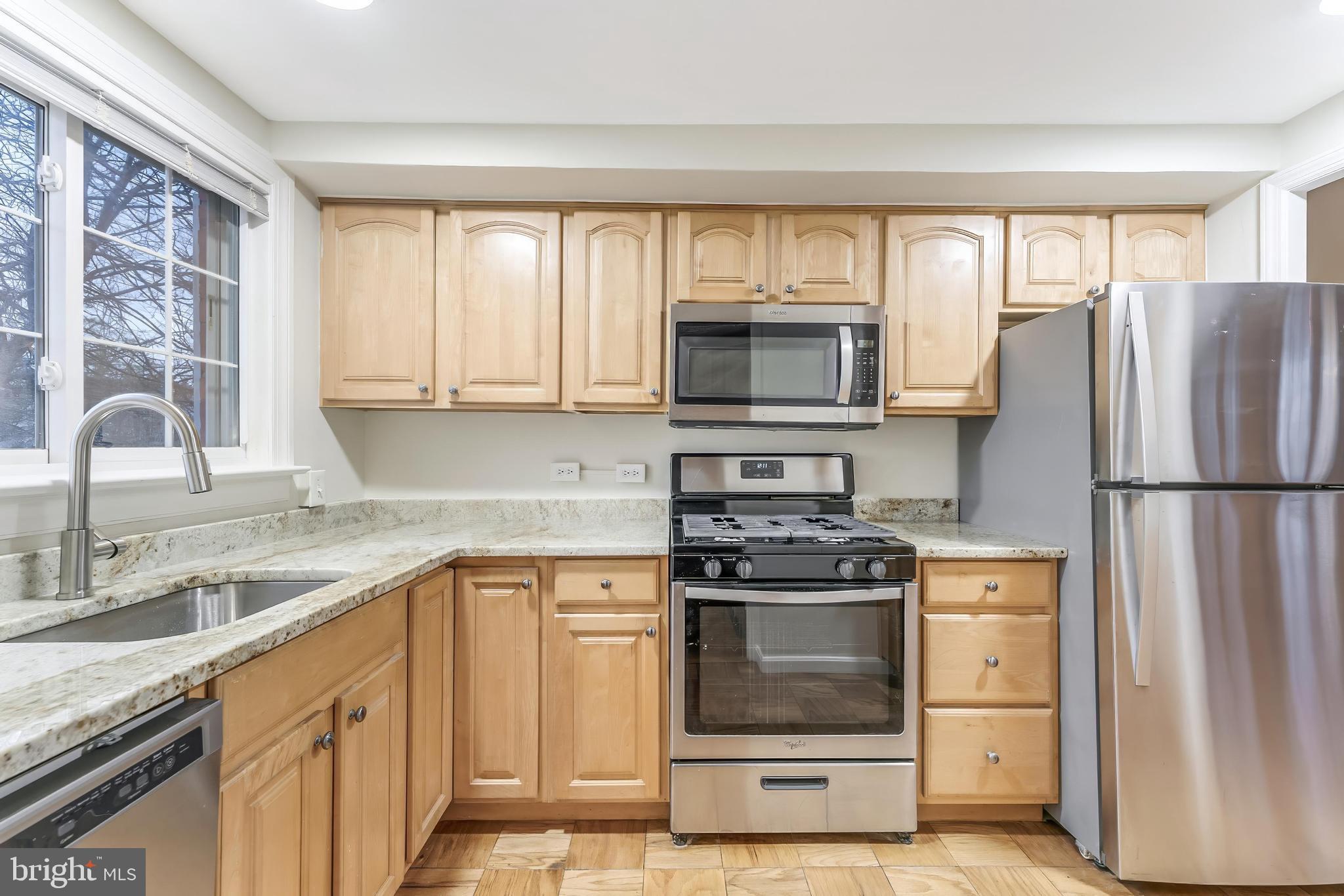 3228 Wellington Road Alexandria, VA 22302 - Photo 5 of 20 a kitchen with a stove a sink and a microwave