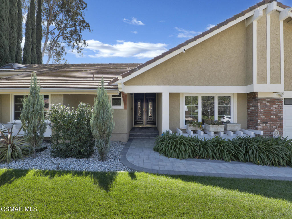 1590 Meander Drive Simi Valley, CA 93065 - Photo 1 of 57 a front view of a house with a yard and potted plants