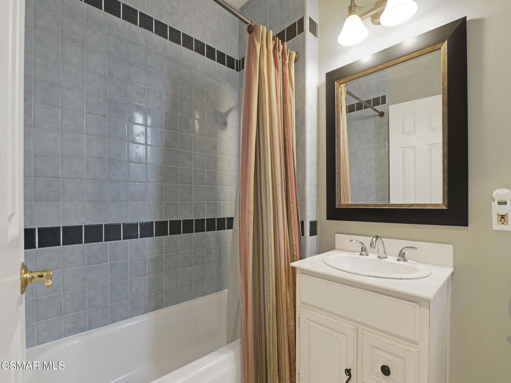 1590 Meander Drive Simi Valley, CA 93065 - Photo 34 of 57 a bathroom with a granite countertop sink a mirror and shower